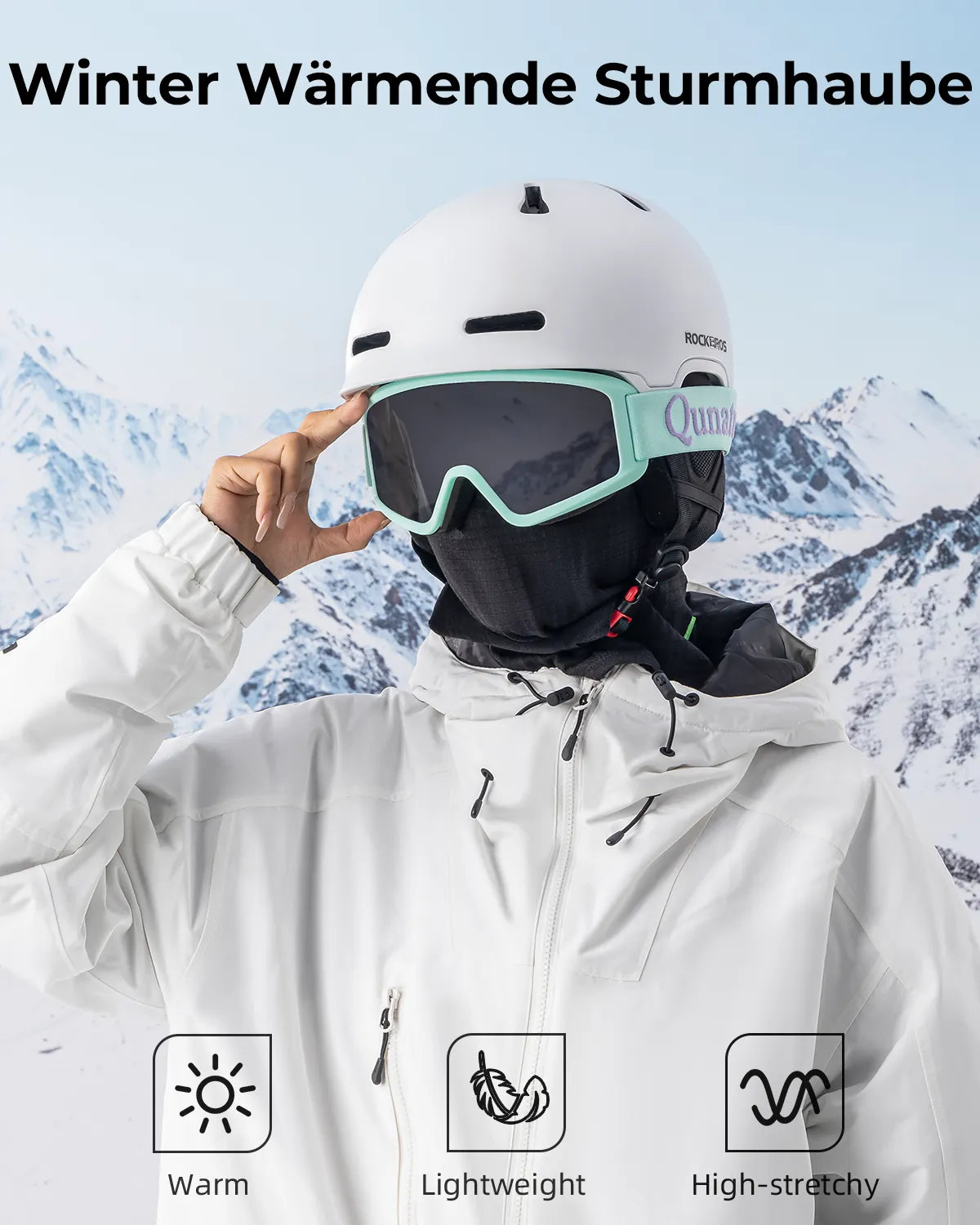 eine skifahrerin in weisser jacke nutzt die schwarze sturmhaube als k?lteschutz.
