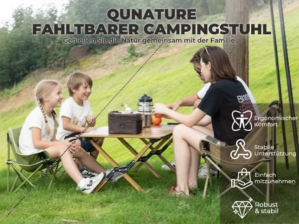 familie sitzt gemeinsam mit klappstühlen beim camping im grünen