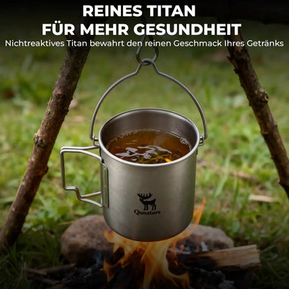  pure titanium camping mug hanging over campfire with tea inside