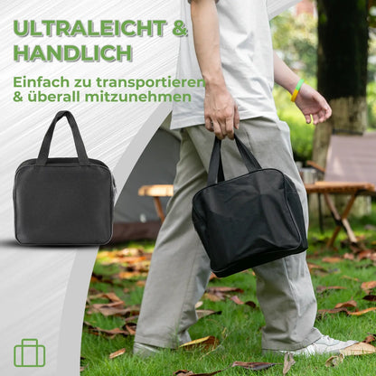 black carry bag being carried outdoors, lightweight and portable gas stove storage