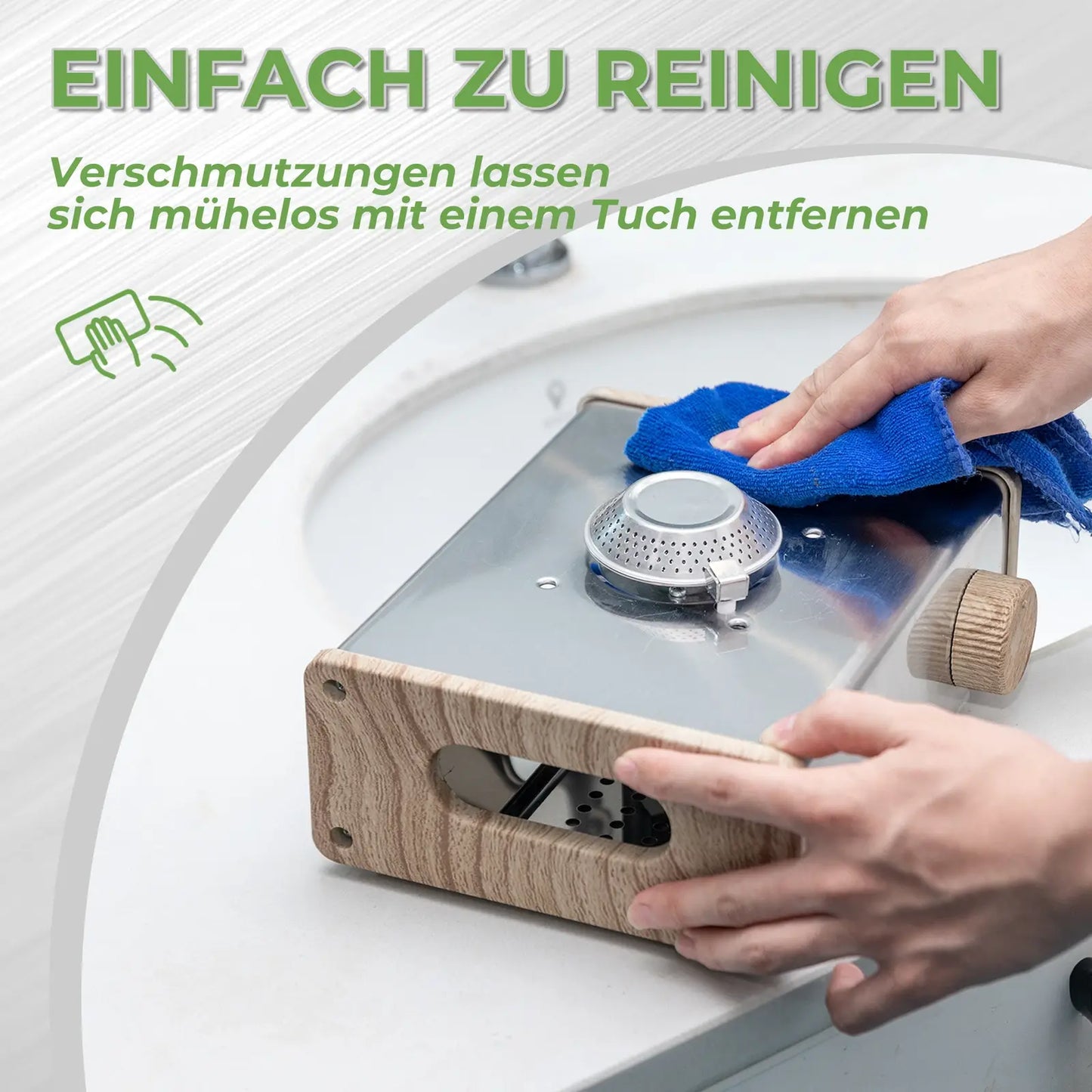 wiping the stainless steel gas stove surface with a blue cloth for cleaning